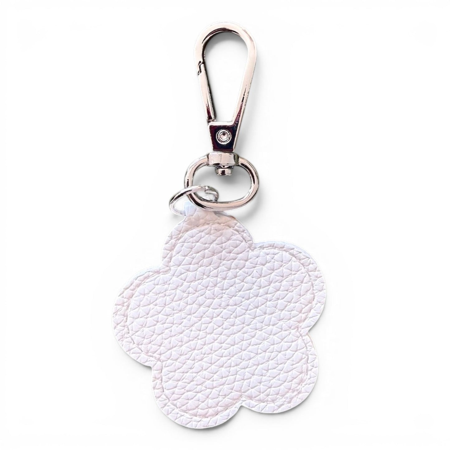 A white faux leather flower-shaped keychain charm with a textured pebbled finish, attached to a silver metal swivel clasp and split ring, shown on a plain white background.