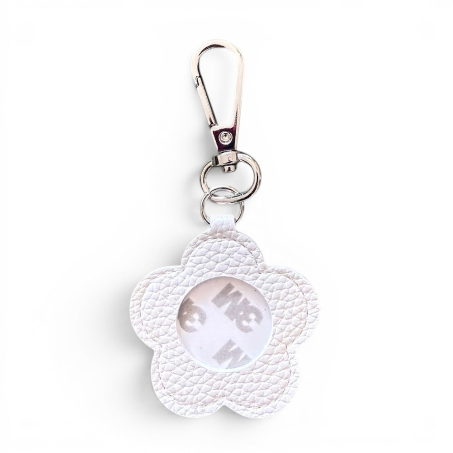 A white textured faux-leather flower-shaped keychain with a silver metal clasp and a 3m adhesive circular center, shown on a plain white background.