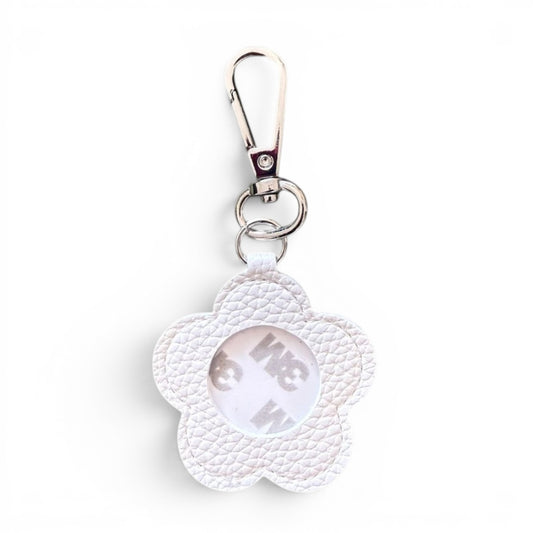 A white textured faux-leather flower-shaped keychain with a silver metal clasp and a 3m adhesive circular center, shown on a plain white background.