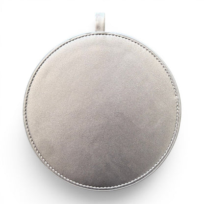A round silver pendant or medallion with a stitched edge and a small loop at the top, shown against a plain white background.